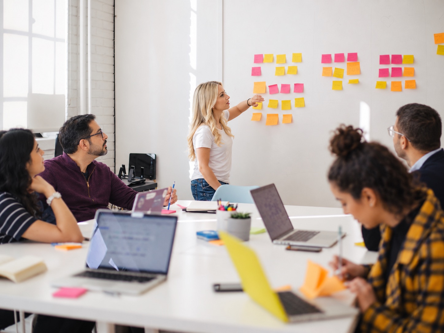 A programme team mapping requirements with sticky notes during a workshop
